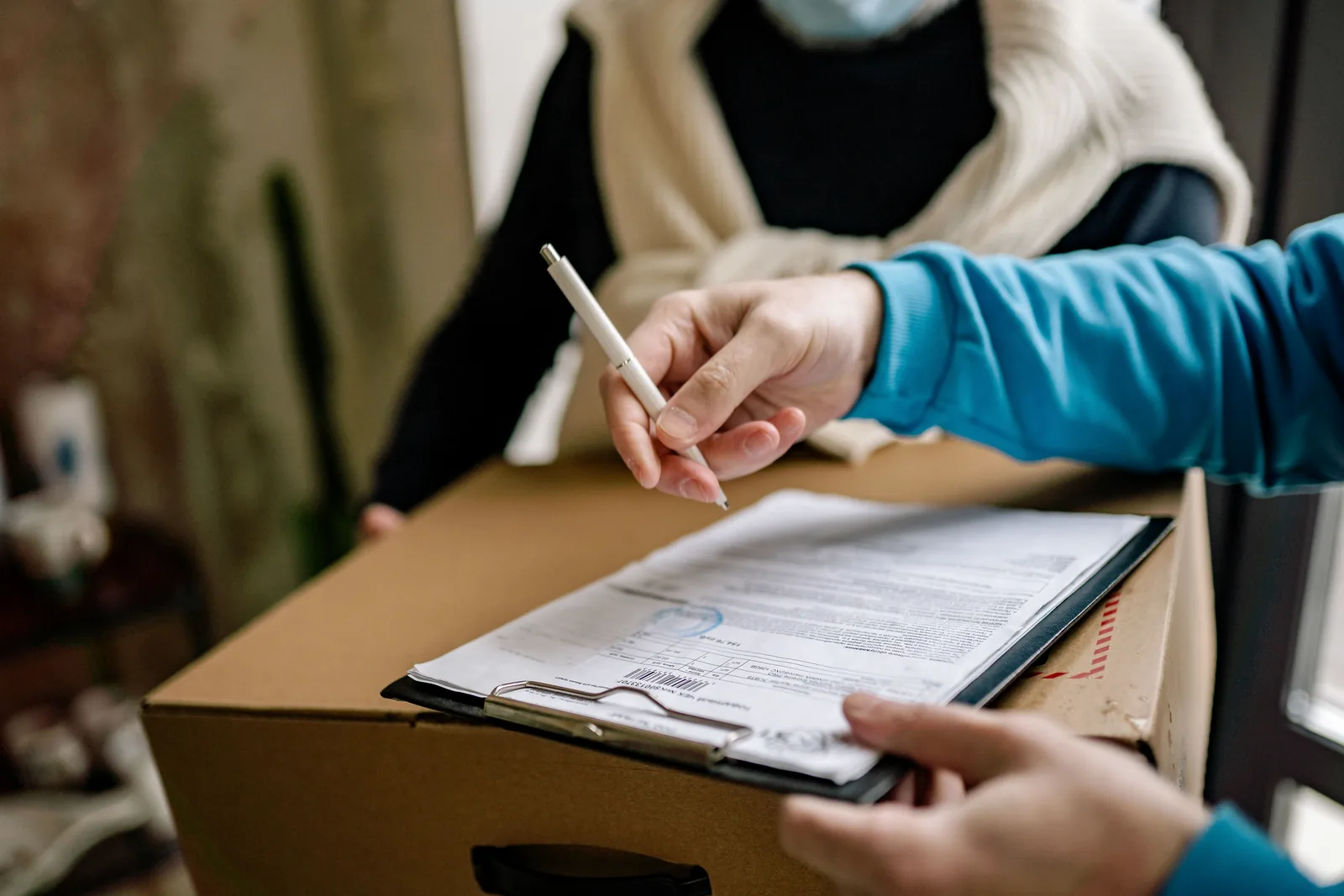 A person signs a work document.